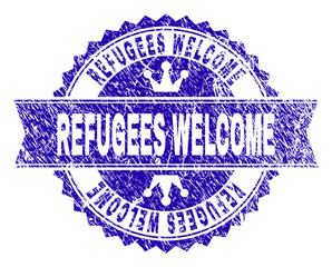 REFUGEES WELCOME rosette stamp seal imitation with grunge style. Designed with round rosette, ribbon and small crowns. Blue vector rubber print of REFUGEES WELCOME tag with unclean style.
