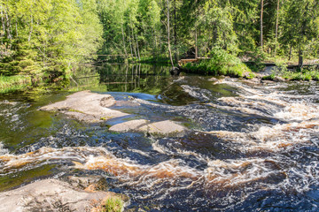 Foamy streams of water Tahmayoki River on the waterfall Ahinkoski