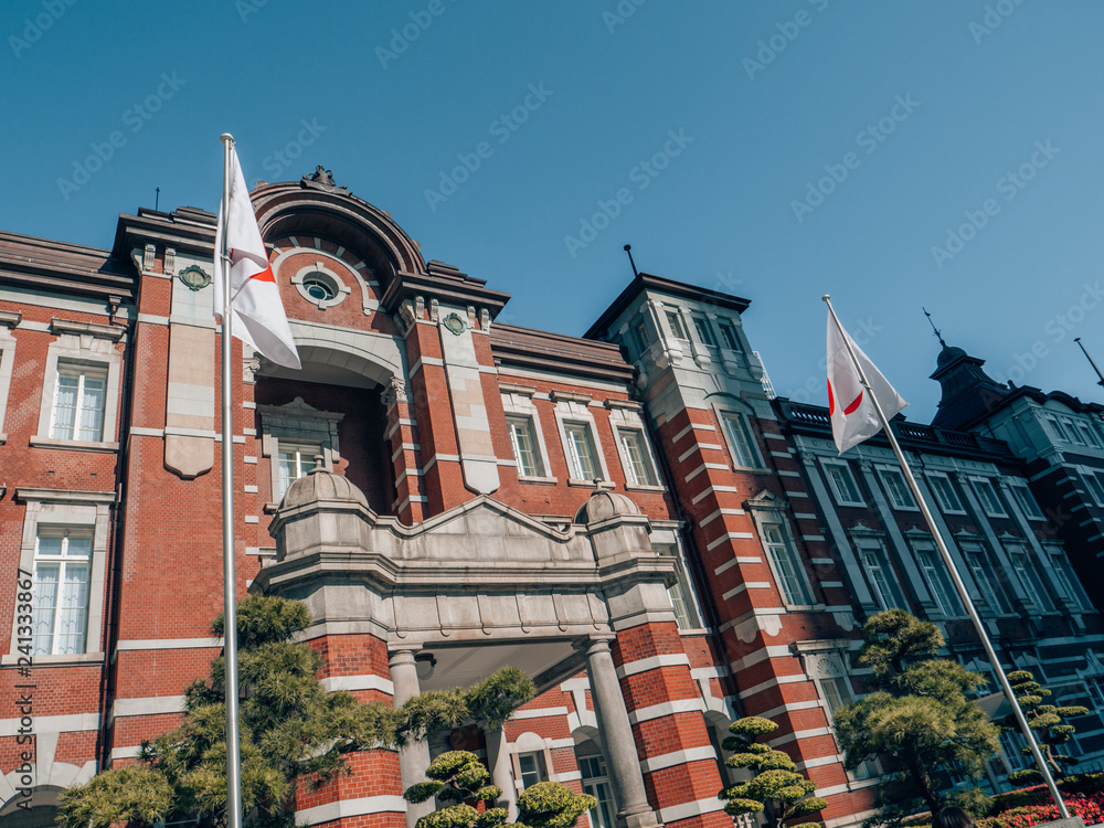 Poster tokyo station in tokyo, japan on a sunny day