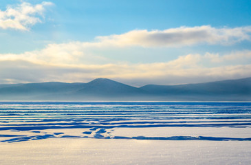 Snow on the river near the mountains