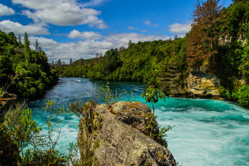 Fototapeta na wymiar Scenic landscape view of turquoise water of Waikato river and Huka Falls,most popular natural tourist attraction/destination. Great lake Taupo,North Island, New Zealand. Summer active holiday concept.