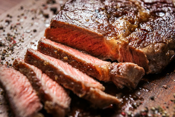 tasty and fresh, very juicy ribbey steak of marbled beef, on a wooden table.