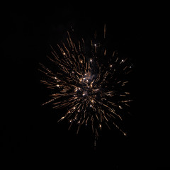 Obraz premium Yellow orange firework against night sky close up