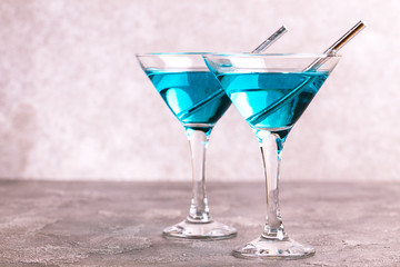 Two glasses of trendy blue wine with paper straws