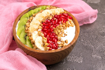 Vanilla acai bowl with kiwi, banana, pomegranate and granola