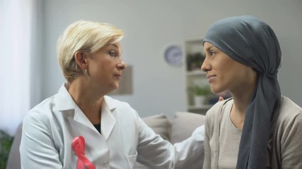 Female doctor supporting cancer patient, giving hope for healing from disease
