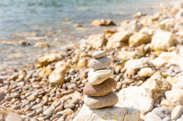 Fototapeta na wymiar Zen balanced stacked stones at the beach