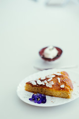 piece of orange and almond cake with cream on the table