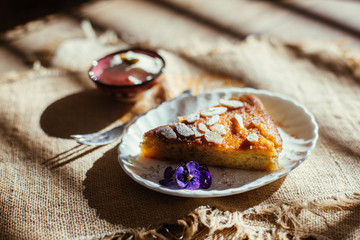 piece of orange and almond cake with cream on the table