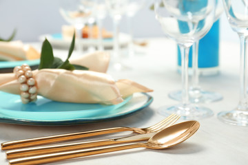 Beautiful table setting with cutlery, glasses, napkin and plate, closeup