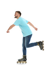 Young man with inline roller skates on white background