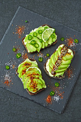 Appetizing avocado toasts with beautiful toppings.