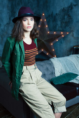 young pretty woman waiting alone in modern loft studio, fashion 