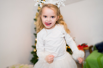little girl in a dress dancing at home having fun