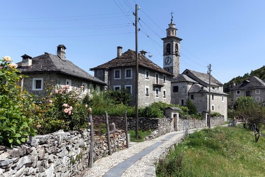 Townscape, typical Ticino stone houses and parish church of Sant' Anna in the mountain village Rasa, Centovalli, canton Ticino, Switzerland, Europe