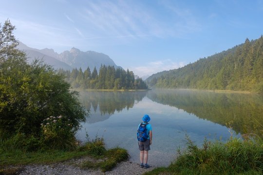 Woman with backpack at Isarstausee Krun, Karwendelbebirge, Werdenfelser Land, Upper Bavaria, Bavaria, Germany, Europe