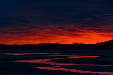 Blue hour with red sky and red reflection in Lech river, Forggensee, Fussen, Ostallgau, Bavaria, Germany, Europe