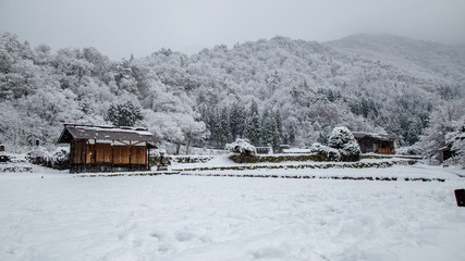 Shirakawa-go village during snowing in winter including traditional House Gassho style and one of UNESCO world heritage sites, Gifu, Japan