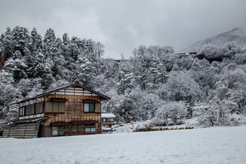 Traditional Guesthouse Gassho style one of UNESCO world heritage sites in Shirakawa-go village area with snow cover on winter locate at Gifu, Japan