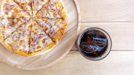 Pizza in a wooden tray and soft drink. Eat fat not good for health. Concept Junk food,  on wood white background. Blank for design.