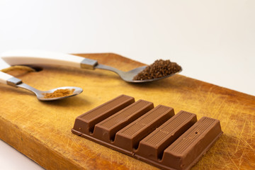 Chocolate bars on a rustic wooden board. Sweet food