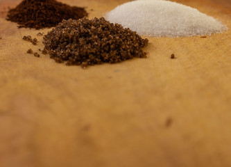 Three small mountains of coffee, white and black sugar
