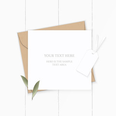 Flat lay top view elegant white composition letter kraft paper envelope nature leaf and tag on wooden background
