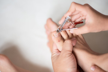 Father cut foot nail for son