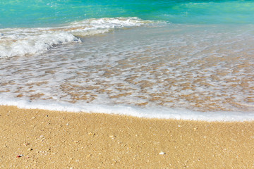 Wave of surf on the sea coast, clean sea shore and turquoise water