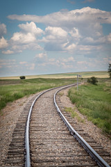 Rural train tracks in a field