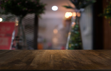 Empty dark wooden table in front of abstract blurred bokeh background of restaurant . can be used for display or montage your products.Mock up for space.