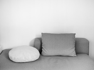 Fototapeta na wymiar White and gray pillows on sofa in cozy living room
