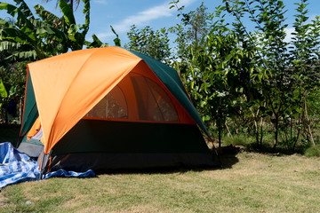 Tent Green orange pattern On the lawn in the garden under the sky with strong sunlight in winter.