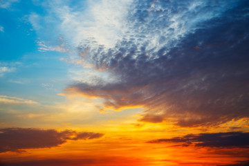 Naklejka na ściany i meble Sky blue and orange light of the sun through the clouds in the sky