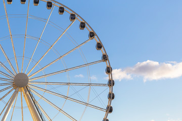 A ferris wheel during a day with blue skyes