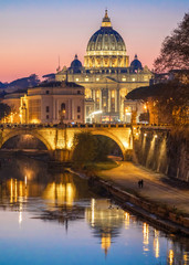 Fototapeta na wymiar Rome (Italy) - The Tiber river and the monumental Lungotevere at sunset. Here in particular the Saint Peter basilica in Vatican