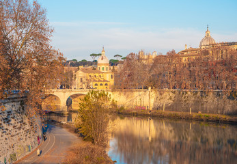 Fototapeta na wymiar Rome (Italy) - The Tiber river and the monumental Lungotevere at sunset. 