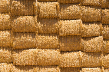 Stack hay wall in rural Australian countryside. Agricultural farming landscape