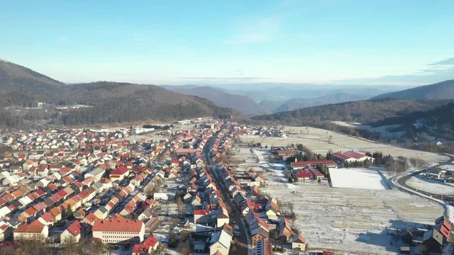 Panoramic view of Croatian town Delnice, Gorski Kotar in winter, slow drone flight over the town center 