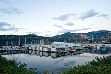 Bay with floating houses and moored yachts in Colombia River Gorge