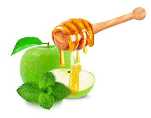 green apple and dripping honey isolated on white