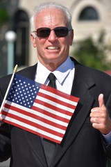 Male Politician With Thumbs Up Wearing Business Suit
