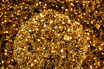 The golden LED light bokeh blurred abstract pattern background.