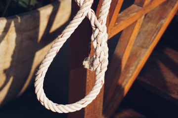 The old white rope was tied in a circle.