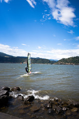 Surfer confidently glides over the waves driven by fair wind