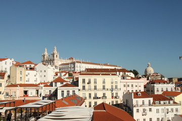 Fototapeta na wymiar White houses with red rooftops and blue sky