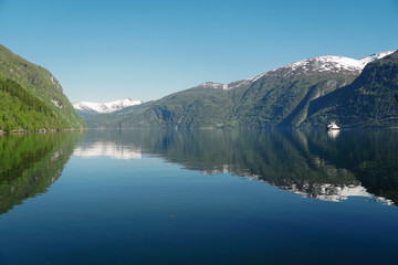 Norway beautiful spring landscape. Mountains reflection in calm water of fjord
