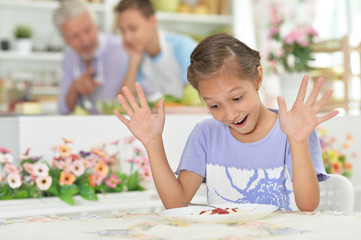 Portrait of cute little girl having healthy breakfast