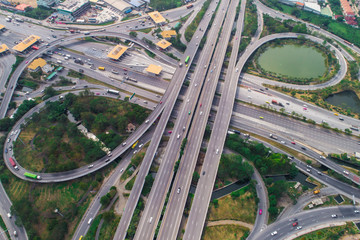 Transport junction circular city road aerial view with green tree