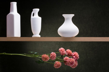 Naklejka premium Still life with white vases and a flower branch